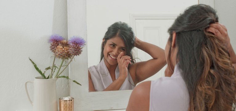 woman smiling in mirror